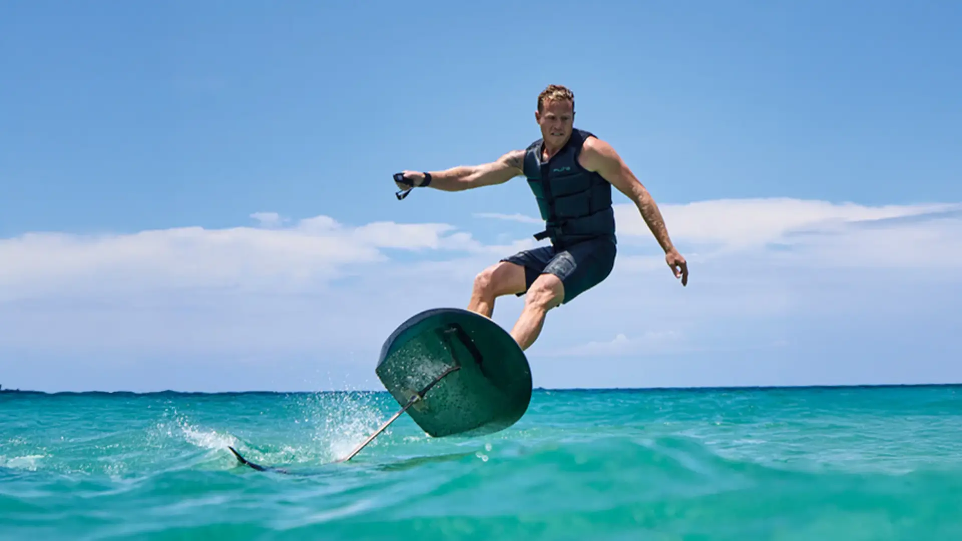 A man takes a steep turn with a fliteboard on the sea.