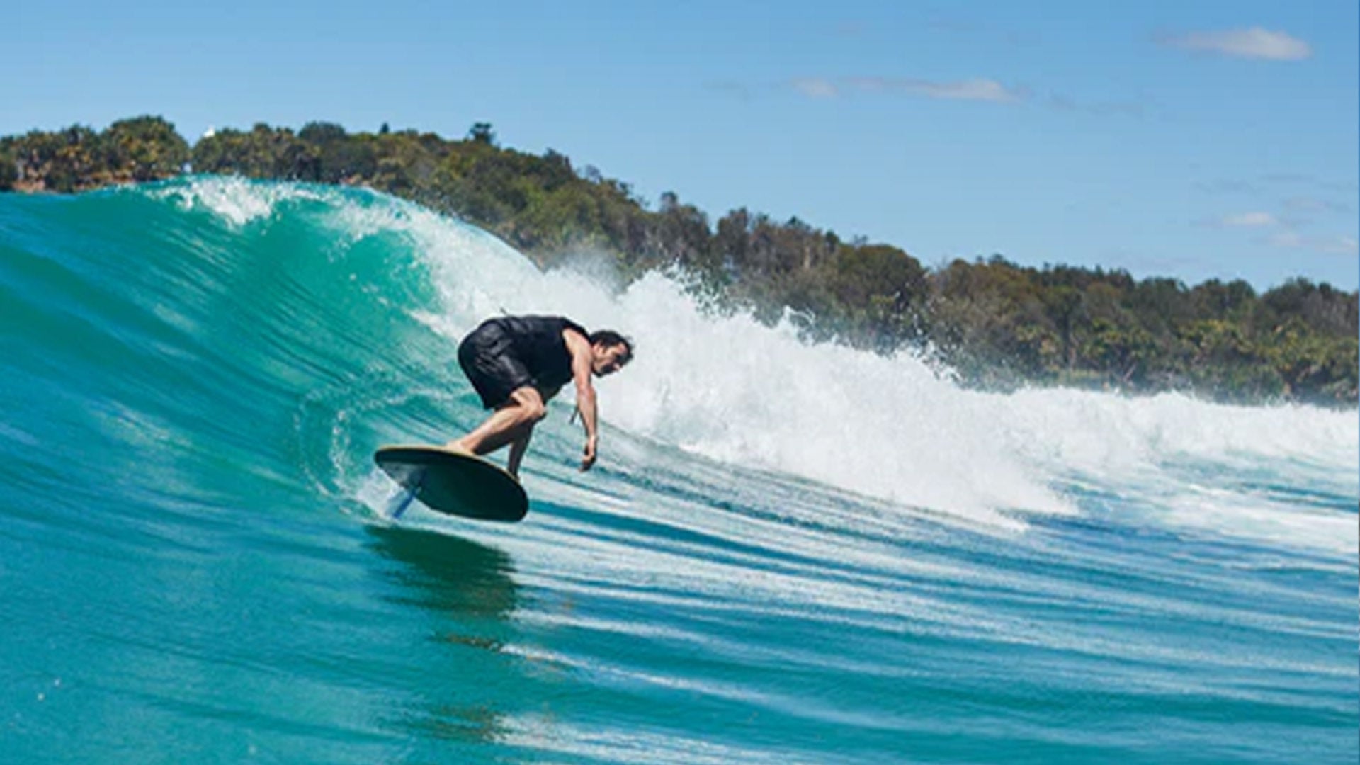 A man surfs a wave with a fliteboard.
