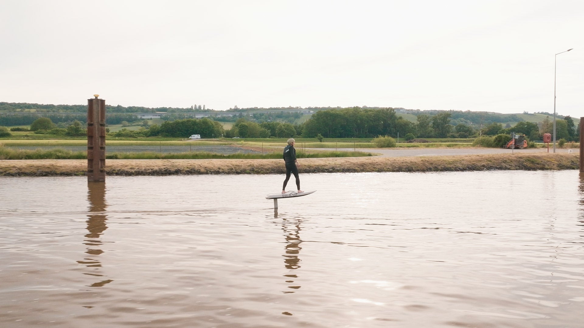 A man efoils with his Fliteboard on the river in Mannheim.