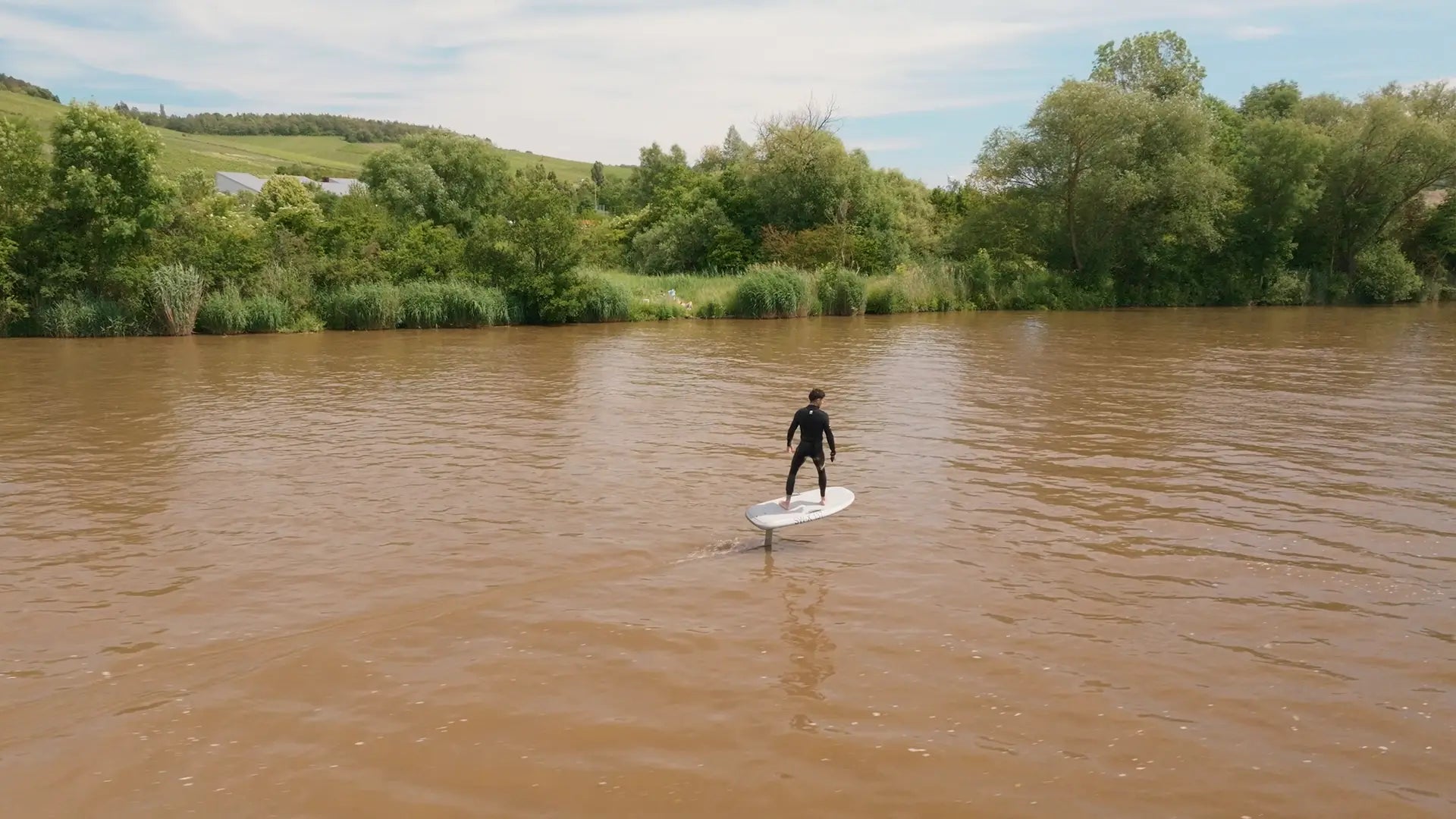 A person foiling with a fliteboard on a river in Germany.