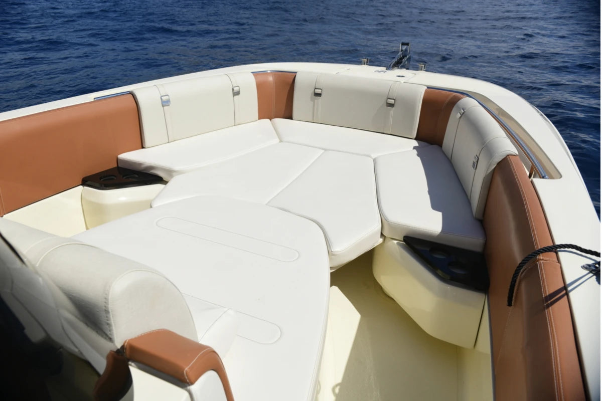Boat interior with white and brown seats on a body of water