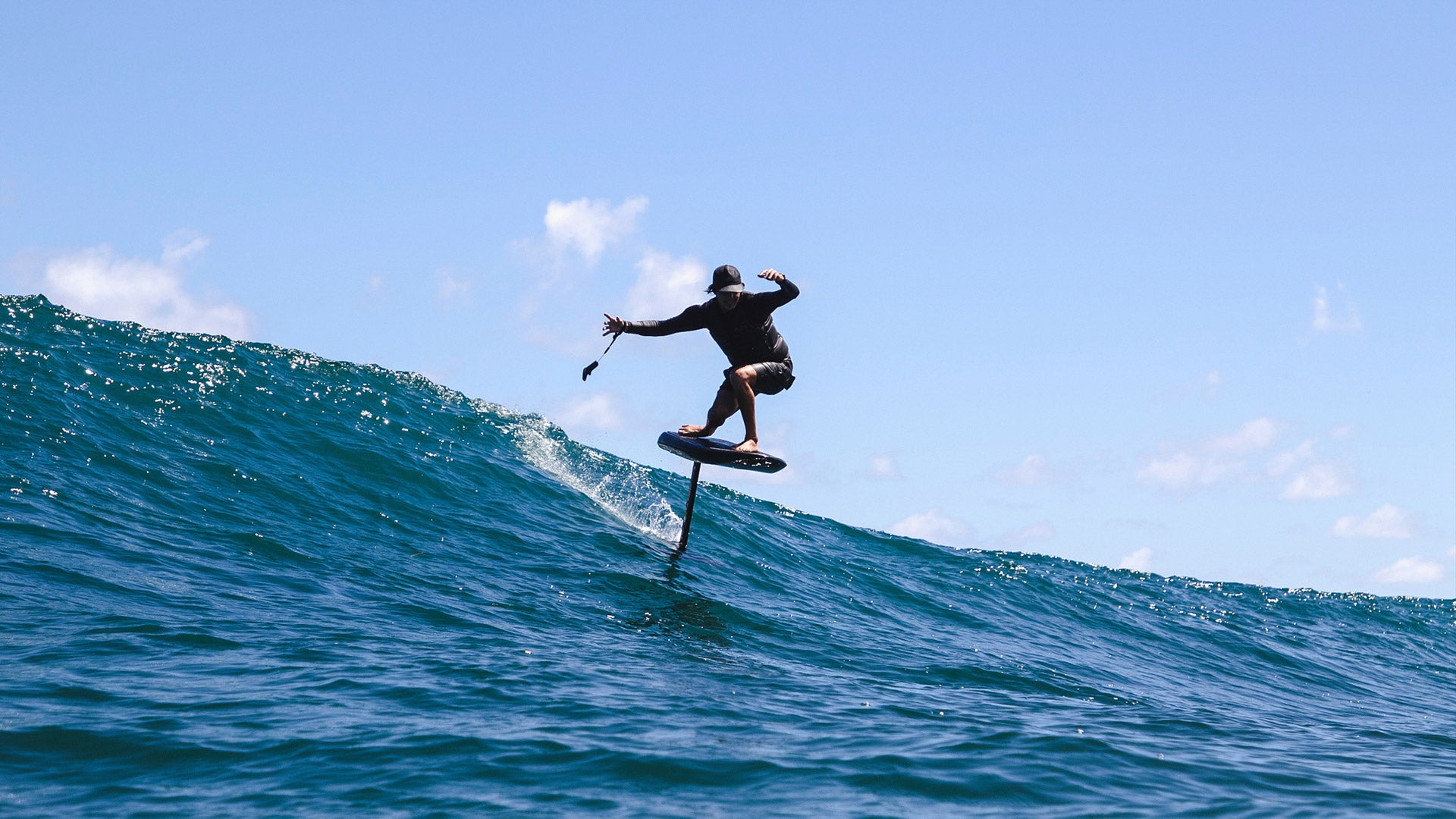 A man efoils on a wave in the sea.