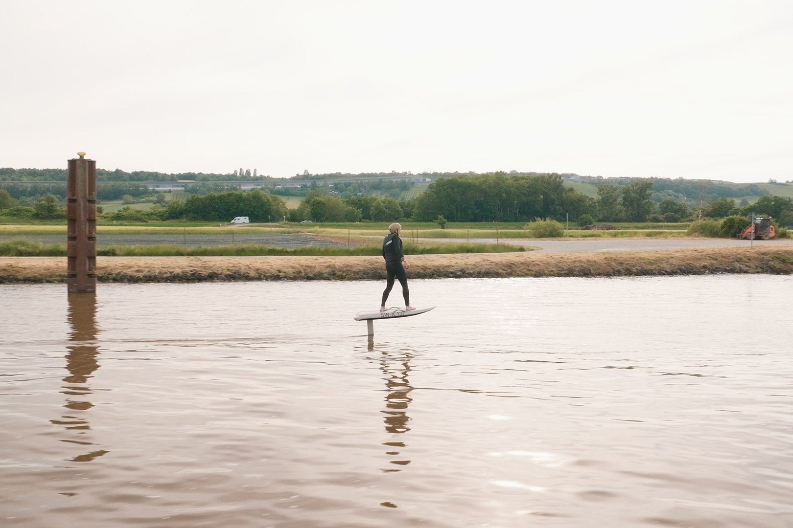 A man efoils with his Fliteboard on the river in Mannheim.